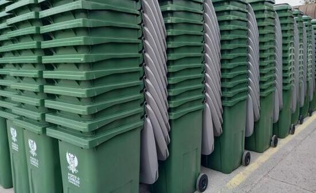 Stacked grey-lidded wheeled bins